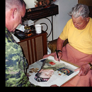 Smokey Smith VC signing his portrait with John Perry